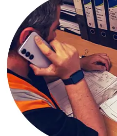 Image of someone in a hi-vis jacket on the phone